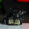 Glossy black resin lion ornament with gold plaque featuring Tangying lucky charm - Obsidian