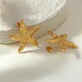 Golden starfish stud earrings with realistic textured finish on white stone background - Spiral Starfish Style (FYD6231EH)