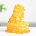 Golden translucent resin lion statue featuring traditional Chinese guardian beast design - Citrine