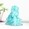 Translucent cyan crystal lion statue with resin fill and ornate base for home decor - Aquamarine