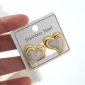 Macro detail of heart-shaped stainless steel earrings with white marble texture inlay - Heart Earrings (FYD6165EH)