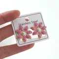 Pink petal stainless steel earrings with pearl center and golden edges in hand - Pink Flower Earrings (FYD6232EH)