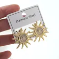 Golden sunburst stainless steel stud earrings with white spiral center detail - Sun Earrings (FYD6130EH)