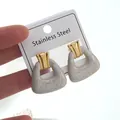 Golden stainless steel geometric drop earrings with marble resin detail on white card - Bag Shape Earrings (FYD6140EH)
