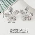 Macro view of silver flower earrings with hammered texture and precise size measurements - Hq6029-1