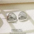 Macro view of geometric stainless steel earrings with wavy texture and dimensions - Wavy Round (FYD6079-1)