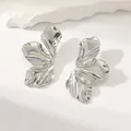 Macro shot of silver titanium steel floral earrings with polished ripple texture on stone - Abstract Flower Butterfly (HQ6006-1)