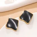 Detailed close-up of geometric gold-plated earrings with black enamel inlay in square shape - Black
