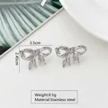 Detail view of silver bow-shaped stainless steel earrings with size and weight specs - Bowknot Hollow (HQ6001-1)