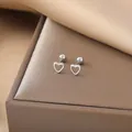 Detail of silver hollow heart stud earrings with secure screw back ball closure - Hollow Heart / Steel