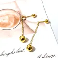 Detail of golden tassel earrings with faceted spheres on a stylish lifestyle background - Soccer Ball Tassel / Gold