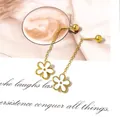 Macro detail of gold-plated chain earrings featuring white daisy pendants and stud balls - White Daisy Tassel / White