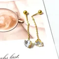 Detail of elegant gold tassel earrings featuring clear heart-shaped cubic zirconia stones - White Crystal Heart Tassel / One Pair / Gold