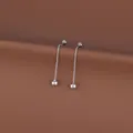 Detailed view of silver flower tassel drop earrings on a minimalist brown background - Ball Tassel / 1 Pair Pack / Steel