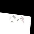 Macro shot of silver snake earrings with detailed scale texture and ball closure - Snake U-Shape / Silver