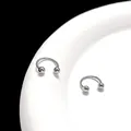Macro shot of silver horseshoe rings with screw balls on a white plate with black background - Smooth Round / 3mm (1 Piece) / Silver