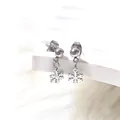 Detail shot of silver snowflake earrings with ball studs on white plush background - Snowflake