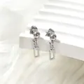 Macro shot of silver titanium steel ball stud earrings with minimalist hollow rectangle drop - Rectangle