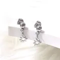 Detailed macro view of silver titanium steel ball stud earrings with hollow sun pendant - Sunflower