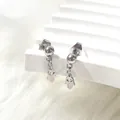 Detail of silver Hamsa skull hollow earrings in titanium steel with punk style design - Little Hands