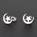 Macro shot of silver crescent moon and star stud earrings with polished metal finish - Silver