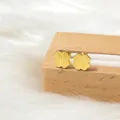 Gros plan de boucles d'oreilles trèfle doré avec texture brossée et placage en or 18 carats - Trèfle à Quatre Feuilles Boule de Torsion / Or