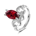 Macro shot of marquise-cut ruby ring with silver scrollwork and micro-pave stones - Adjustable Open / Ruby Red (QHJ004)