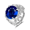 Macro detail of silver ring featuring a large round blue gemstone and bark texture - Blue Zirconia (QHJ005)