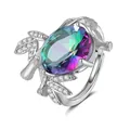 Macro view of luxurious silver ring featuring a large rainbow topaz and leaf details - Adjustable Open / Rainbow Stone