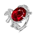 Macro detail of the oversized oval red gemstone and intricate silver vine ring band - Adjustable Open / Ruby