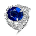 Macro shot showing detail of large oval blue sapphire with clear side stones on a silver band - Adjustable Open / Sapphire