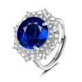 Macro detail of royal blue gemstone ring with claw-set crystals and floral镂空 side design - Adjustable Open / Sapphire