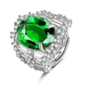 Detailed macro view of an oval green gemstone set in a multi-layer silver ring with diamonds - Adjustable Open / Emerald