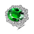Macro shot of oval green crystal ring with multilayered white zircon flower petals - Adjustable Open / Emerald Green