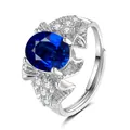 Detailed macro view of large oval blue gemstone and white diamonds on silver ring - Rose Shape (QHJ010) / Sapphire Blue