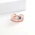 Detail view of rose gold crown ring with colorful rectangular gems and wavy diamond band - Rose Gold