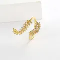 Detailed close-up of a gold-plated olive branch open ring with sparkling white crystals - Adjustable Open / Gold Feather Ring