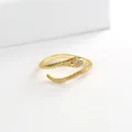 Detailed view of gold plated snake ring featuring sparkling white stones and green eyes - Gold