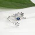 Macro detail of silver evil eye adjustable ring with blue gemstone and lash accents - Silver