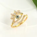 Macro shot of gold evil eye open ring featuring blue crystals and sparkling white zircons - Adjustable Open / Gold
