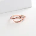 Close-up of rose gold snake ring with green gem eyes and white zircon scale details - Rose Gold
