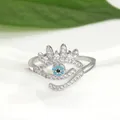 Detailed close-up of a silver-toned evil eye open ring featuring blue and white zircons - Adjustable Open / Silver