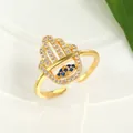 Macro shot of Hamsa hand ring with blue evil eye and sparkling white zircon stones - Adjustable Open / Gold