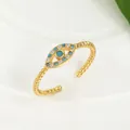 Macro detail of Evil Eye open ring with blue bead, white stones and twisted band texture - Adjustable Open / Gold