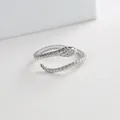 Close-up of silver snake ring featuring green gemstone eyes and micro-paved zircons - Silver