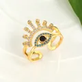 Detail of gold evil eye open ring with blue stones on a clean white tray - Adjustable Open / Gold