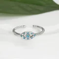 Detailed macro view of an evil eye open ring with blue stones and twisted band design - Adjustable Open / Silver
