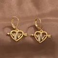Detailed view of golden leverback heart earrings with sparkling heartbeat line on brown silk - Gold