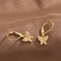 Detailed macro view of gold butterfly lever-back earrings with micro-pave cubic zirconia - Gold