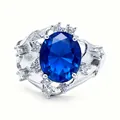 Elegant silver ring with a large oval blue gemstone and shimmering round side stones - QHJ006 Platinum Blue Stone / Sapphire Blue